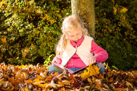 portrait of smiling girl in colorful autumnal atmosphereの写真素材