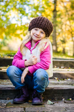 portrait of smiling girl in colorful autumnal atmosphereの写真素材