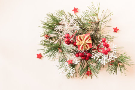 simple christmas tree with pine branch and red decorations on red backgroundの写真素材