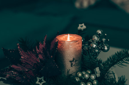 burning candles on advent decoration, luxurious and magic with christmas tree lightsの写真素材