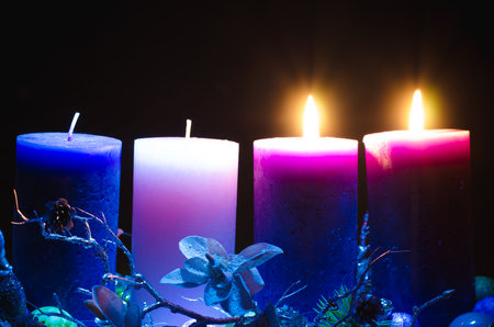 burning candle and chrysanthemum flower decoration on grave in the cemeteryの写真素材