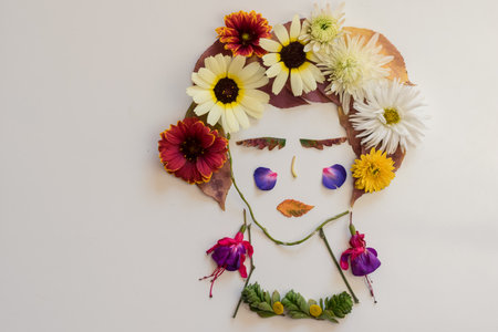 cute figures, dancers made from colorful leaves and bright flowers on white backgroundの写真素材
