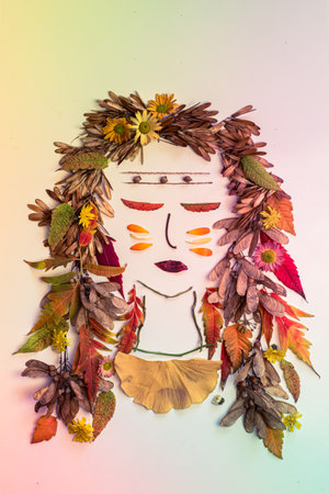cat made from vivid autumnal leaves and flowers, isolated on white backgroundの写真素材