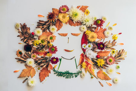 cat made from vivid autumnal leaves and flowers, isolated on white backgroundの写真素材