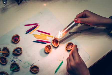 European christmas tradition, preparing nutshells and little candles for water surfaceの写真素材