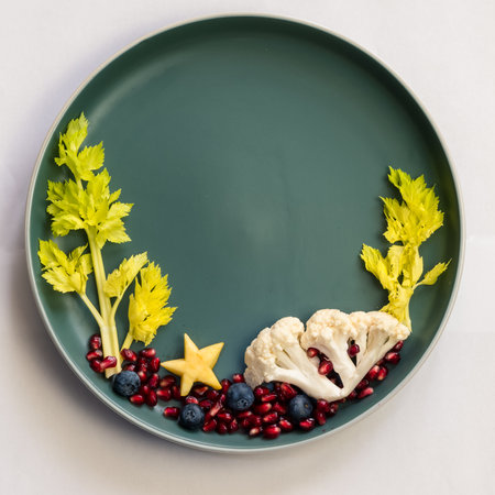 sea world from blackberries, salad and cauliflower, isolated colorful food ideas on plate, copy spaceの写真素材
