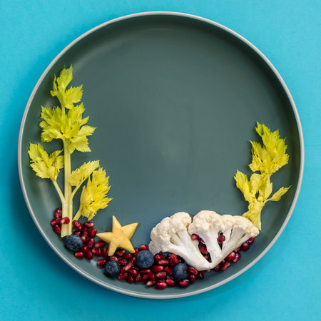corals and plants in sea world from blackberries, salad and cauliflower, isolated colorful food ideas on plate, copy spaceの写真素材