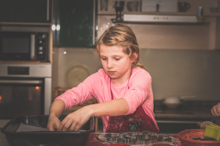 children preparing christmas gingerbread in the kitchen, festive atmosphere