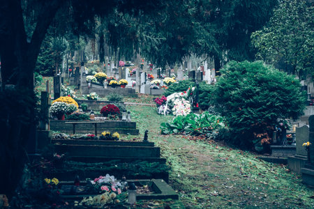 graves decorated with lanterns, burning candles, colorful chrysanthemum flowers, catholic symbols