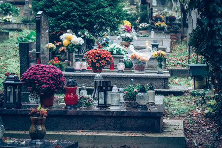 graves decorated with lanterns, burning candles, colorful chrysanthemum flowers, catholic symbolsの写真素材