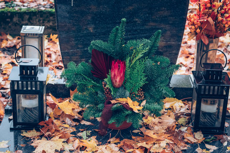 graves decorated with lanterns, burning candles, colorful chrysanthemum flowers, catholic symbolsの写真素材