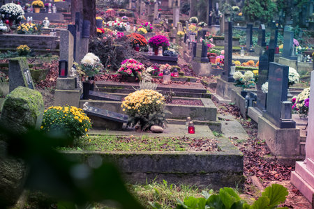 graves decorated with lanterns, burning candles, colorful chrysanthemum flowers, catholic symbolsの写真素材