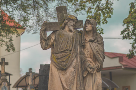 christian religious statue from rock in the cemetery