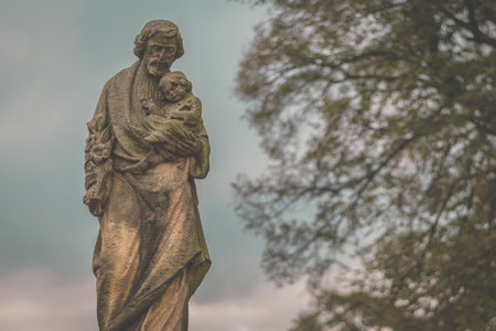 christian religious statue from rock in the cemetery