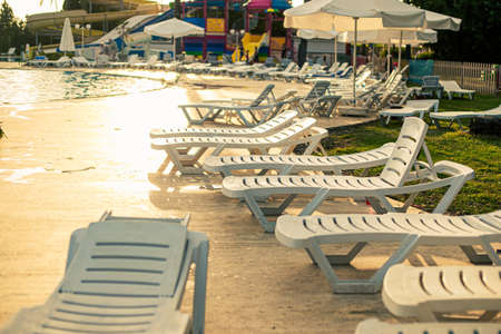 Many sun loungers by the pool in the hotelの写真素材