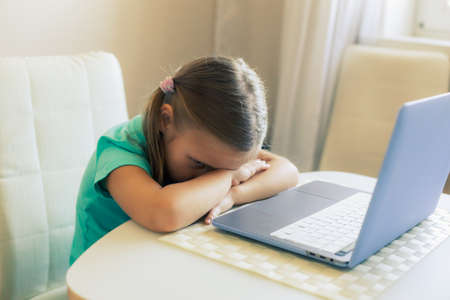 Little cute girl uses laptop to have video call