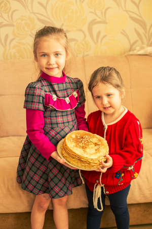 Happy little girls with pancakes.Two funny sistersの写真素材