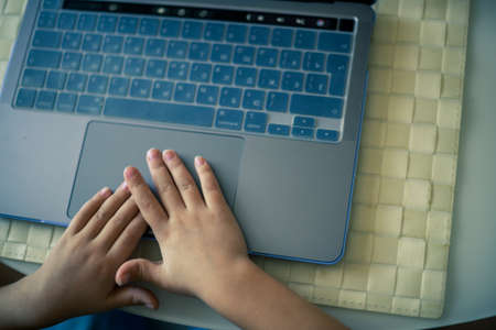 Little cute girl opens laptop to have video callの写真素材