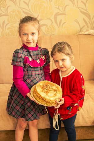 Happy little girls with pancakes.Two funny sistersの写真素材