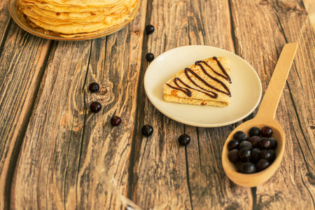 Delicious pancakes with chocolate sauce fresh blueberries on a rustic wooden table. Rustic brown table.の写真素材
