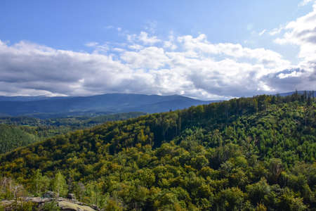 A view of green fields, forests and mountains in the Giant Mountains from above.の写真素材