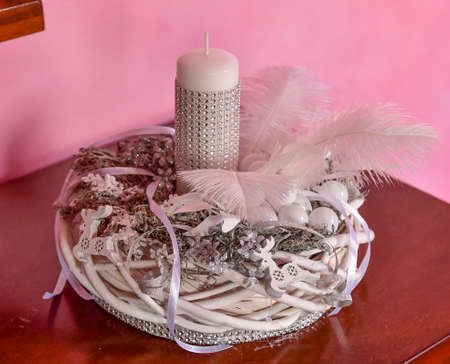 A white Christmas headdress, richly decorated on a pink background.の写真素材
