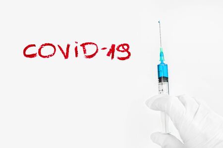 Covid medicament vaccine and syringe injection with silicone glovesの写真素材