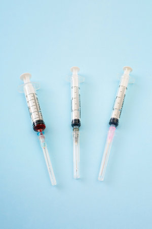 Syringes on blue medical background