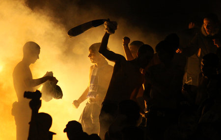 LUTSK, UKRAINE - OCTOBER 24, 2010: FC Dynamo Kyiv ultras (ultra supporters) burn flares during...