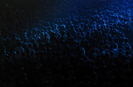 Cheering crowd at the rock concert in a concert hallの写真素材