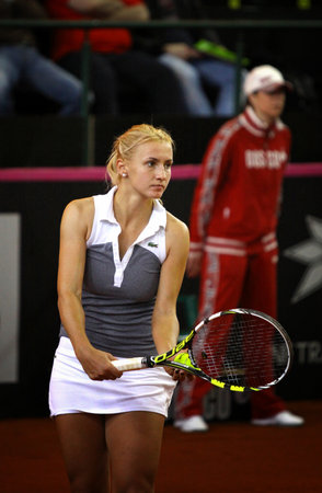 KYIV, UKRAINE - APRIL 21, 2013: Lesia Tsurenko of Ukraine prepares to serve during BNP Paribas FedCup game against Eugenie Bouchard of Canada on April 21, 2013 in Kyiv, Ukraineのeditorial素材