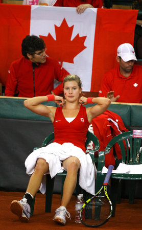 KYIV, UKRAINE - APRIL 21, 2013: Eugenie Bouchard of Canada takes a break during BNP Paribas FedCup game against Lesia Tsurenko of Ukraine on April 21, 2013 in Kyiv, Ukraineのeditorial素材