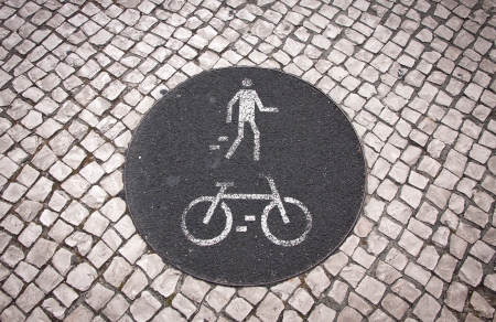 Bicycle and pedestrian lane road sign on the ground in Lisbon, Portugal