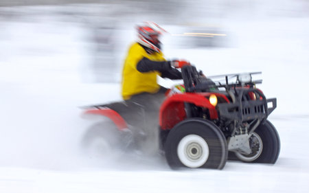 KYIV, UKRAINE - FEBRUARY 13, 2010  Quad bike driver Mykhaylo Ersh  Yamaha Grizzly 660  rides over snow track during Baja Kyiv-2010 Rallyのeditorial素材