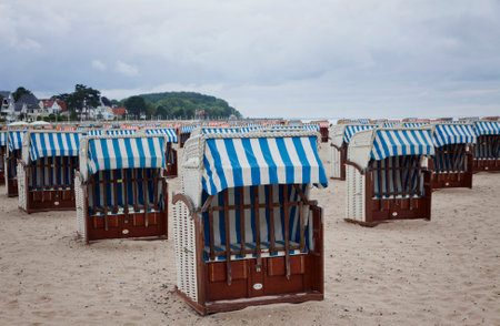 Hooded beach chairs  strandkorb  at the Baltic seacoast in Travemunde, Germanyのeditorial素材