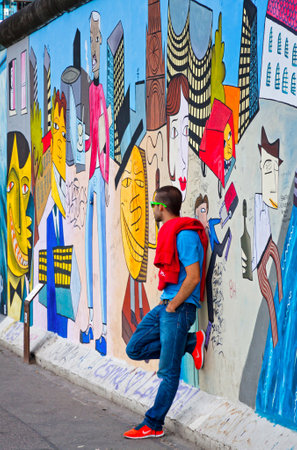 BERLIN, GERMANY - JULY 2, 2014: Fragment of East Side Gallery in Berlin. It is a 1.3 km long part of original Berlin Wall which collapsed in 1989 and now is the largest world graffiti galleryのeditorial素材