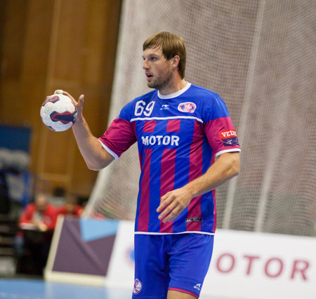 KYIV, UKRAINE - OCTOBER 18, 2014: Sergii Burka of Motor controls a ball during European Handball Champions League game against Aalborgのeditorial素材
