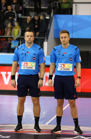KYIV, UKRAINE - MARCH 19, 2016: Referees Martin Gjeding (L) and Mads Hansen (both from Denmark) look on during the 2015/16 VELUX EHF Champions League Last 16 Handball game HC Motor vs MVM Veszpremのeditorial素材