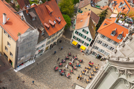 KONSTANZ, GERMANY - MAY 7, 2013: People sitting at outdoors cafe on the Munsterplatz square in old...