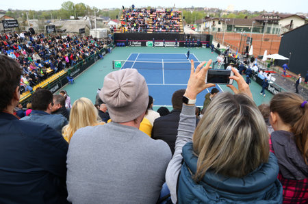 KYIV, UKRAINE - APRIL 16, 2016: People watch the BNP Paribas FedCup World Group II Play-off game Lesia Tsurenko of Ukraine vs Nadia Podoroska of Argentina at Campa Bucha Tennis Club in Kyiv, Ukraineのeditorial素材