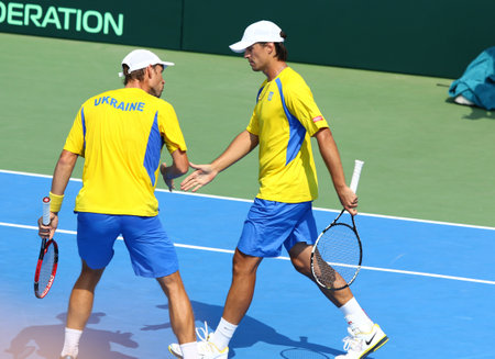 KYIV, UKRAINE - JULY 16, 2016: Denys MOLCHANOV (R) and Artem SMIRNOV of Ukraine react during BNP Paribas Davis Cup pair game against Austria at Campa Bucha Tennis Club in Kyiv, Ukraineのeditorial素材
