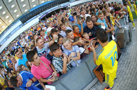 KYIV, UKRAINE - AUGUST 29, 2016: Player Yevhen Konoplyanka gives an autographs during Open training session of Ukraine National Football Team before FIFA World Cup 2018 Qualifying matchesのeditorial素材