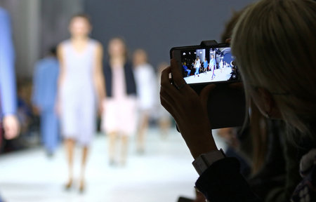 KYIV, UKRAINE - OCTOBER 15, 2016: People takes a picture of models on the catwalk during Fashion...
