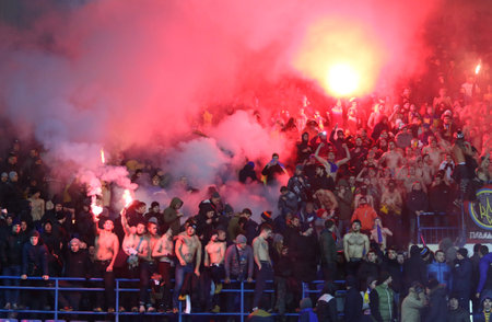 Kharkiv, Ukraine - November 15, 2016: Ukrainian ultra supporters (ultras) burn flares during Friendly match between Ukraine and Serbia at Metalist stadium in Kharkiv, Ukraine. Ukraine won 2-0のeditorial素材