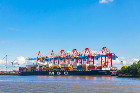 HAMBURG, GERMANY - JUNE 25, 2014: Docks of Port of Hamburg (Hamburger Hafen) on the river Elbe,...