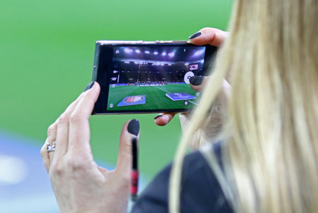KHARKIV, UKRAINE - NOVEMBER 1, 2017: Woman takes a photo of OSK Metalist stadium in Kharkiv on her smartphone before UEFA Champions League game between Shakhtar Donetsk and Feyenoordのeditorial素材