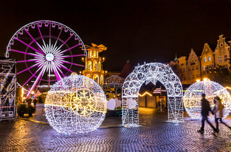 GDANSK, POLAND - DECEMBER 3, 2016: Annual traditional Christmas fair on Targ Weglowy (Coal Market) in center of Gdansk city, Poland. Ferris wheel on the backgroundのeditorial素材