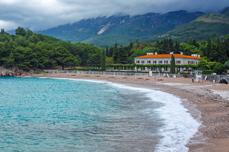 Picturesque summer view of Adriatic seacoast in Budva Riviera. Villa Milocer surrounded by the shady park. Milocer beach (Milocer plaza) on the foreground. Sveti Stefan, Montenegroのeditorial素材