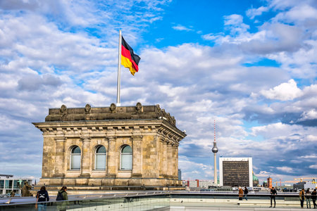 BERLIN, GERMANY - SEPTEMBER 20, 2017: People walking on the roof of Reichstag (Bundestag) building. German flag on the tower and city skyline view on the backgroundのeditorial素材