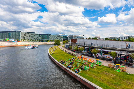 BERLIN, GERMANY - JULY 1, 2014: Sightseeing boats on the river Spree in a sunny summer day in center of Berlin city, Germany. Spreebogenpark on the right. TV-tower on the backgroundのeditorial素材